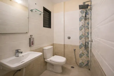 Clean, modern, and hygienic attached washroom in our executive PG near Nahar Amrit Shakti